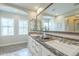 Bright bathroom featuring a large vanity with double sinks and decorative backsplash at 4700 S Fulton Ranch Blvd # 62, Chandler, AZ 85248