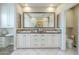 Elegant bathroom with double sink vanity, granite counters, and large framed mirror at 4700 S Fulton Ranch Blvd # 62, Chandler, AZ 85248