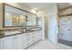 Spacious bathroom with double sinks, stone countertops, and a glass door shower at 4700 S Fulton Ranch Blvd # 62, Chandler, AZ 85248
