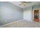Neutral bedroom with plush carpet, closet, and modern ceiling fan at 4700 S Fulton Ranch Blvd # 62, Chandler, AZ 85248
