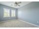 Cozy bedroom featuring plush carpeting, bright windows, and a ceiling fan at 4700 S Fulton Ranch Blvd # 62, Chandler, AZ 85248