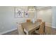 Cozy dining area with a modern chandelier, seating for four, and contemporary artwork at 4700 S Fulton Ranch Blvd # 62, Chandler, AZ 85248