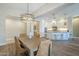 Open-concept dining room adjacent to a kitchen featuring modern light fixtures and ample natural light at 4700 S Fulton Ranch Blvd # 62, Chandler, AZ 85248