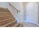 Bright foyer featuring wood stairs, tile flooring, and an arched front door at 4700 S Fulton Ranch Blvd # 62, Chandler, AZ 85248