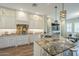 Gourmet kitchen featuring granite countertops, white cabinetry, and a stylish island at 4700 S Fulton Ranch Blvd # 62, Chandler, AZ 85248