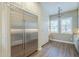 Bright eat-in kitchen features a stainless steel refrigerator, custom cabinetry, and elegant lighting with two windows at 4700 S Fulton Ranch Blvd # 62, Chandler, AZ 85248