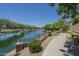 View of a pond with a walking path and mature landscaping at 4700 S Fulton Ranch Blvd # 62, Chandler, AZ 85248