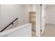 Upstairs hallway showcasing extra shelves, closet and modern railings at 4701 N 68Th St # 214, Scottsdale, AZ 85251