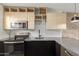 Stylish kitchen with stainless steel appliances, subway tile backsplash and modern wooden cabinetry at 4701 N 68Th St # 214, Scottsdale, AZ 85251
