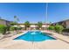 Community pool surrounded by lush landscaping and lounge chairs at 4701 N 68Th St # 214, Scottsdale, AZ 85251