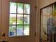 Front door view to an outdoor view with plants in foreground and artwork on the interior wall at 4800 N 68Th St # 164, Scottsdale, AZ 85251