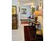 Bright hallway featuring white floors, antique wood furnishings, and colorful art at 4800 N 68Th St # 164, Scottsdale, AZ 85251