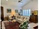 Bright living room features white sofa, exposed brick, eclectic decor and a ceiling fan at 4800 N 68Th St # 164, Scottsdale, AZ 85251