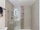 Modern bathroom featuring updated tile, glass shower with rainfall showerhead, and sleek fixtures at 4800 N 68Th St # 207, Scottsdale, AZ 85251