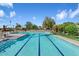 Large community pool with lap lanes and lounge seating at 4800 N 68Th St # 207, Scottsdale, AZ 85251