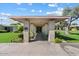 Community entrance featuring brick columns, mature landscaping, and a covered walkway to the property at 4800 N 68Th St # 207, Scottsdale, AZ 85251