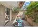 Cozy brick patio with an awning, table and chairs, and lush greenery at 4800 N 68Th St # 207, Scottsdale, AZ 85251