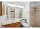 Bathroom featuring a marble countertop, framed mirror, and walk-in shower at 500 E Hermosa Dr, Tempe, AZ 85282