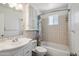 Cozy bathroom featuring a tub/shower combo, sink, and tiled walls, providing a functional space at 500 E Hermosa Dr, Tempe, AZ 85282