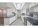 Well-lit kitchen featuring granite countertops, stainless steel appliances, and modern white cabinetry at 500 E Hermosa Dr, Tempe, AZ 85282