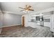 Open-concept living space with sleek floors flowing into a bright kitchen with white cabinetry at 500 E Hermosa Dr, Tempe, AZ 85282