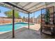 An outdoor covered patio area looks out to a pool and nearby foliage at 500 E Hermosa Dr, Tempe, AZ 85282