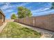 View of backyard featuring grass and a block wall at 6815 W Carter Rd, Laveen, AZ 85339
