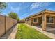 View of backyard featuring grass, a block wall, and a covered patio at 6815 W Carter Rd, Laveen, AZ 85339