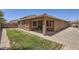 This backyard features a covered patio, a grassy area, and a low-maintenance desert landscape at 6815 W Carter Rd, Laveen, AZ 85339