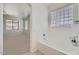 Bathroom featuring a soaking tub, window with blinds, and tile flooring, leading to bedroom at 6815 W Carter Rd, Laveen, AZ 85339