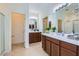 Bathroom features a dual sink vanity, tile flooring, and a glass door shower at 6815 W Carter Rd, Laveen, AZ 85339