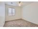 Carpeted bedroom with a ceiling fan and a window providing natural light at 6815 W Carter Rd, Laveen, AZ 85339