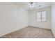 Bedroom with neutral carpet, ceiling fan, and a window with blinds at 6815 W Carter Rd, Laveen, AZ 85339