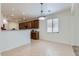 Open dining area featuring tiled floors, a modern light fixture, and direct access to the kitchen at 6815 W Carter Rd, Laveen, AZ 85339