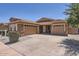 Charming single-story home featuring a three-car garage, tile roof, and well-maintained landscaping at 6815 W Carter Rd, Laveen, AZ 85339