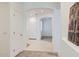 Bright hallway featuring tiled floors, arched entryways, and convenient closet space at 6815 W Carter Rd, Laveen, AZ 85339