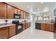 Bright kitchen with granite counters, wooden cabinetry, and open to living area at 6815 W Carter Rd, Laveen, AZ 85339