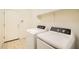 Functional laundry room with modern appliances, tiled floor, and built-in shelving at 6815 W Carter Rd, Laveen, AZ 85339