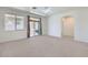 Bright living room with neutral carpet, large windows and sliding door to backyard at 6815 W Carter Rd, Laveen, AZ 85339