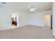 Main bedroom with neutral carpet leading to ensuite bathroom with vanity at 6815 W Carter Rd, Laveen, AZ 85339