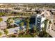Stunning aerial view of resort pool with lush landscaping and urban backdrop with palm trees at 6936 E 4Th St # 5, Scottsdale, AZ 85251