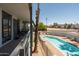 Community pool view from a balcony seating area showing desert landscaping at 6936 E 4Th St # 5, Scottsdale, AZ 85251