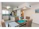 This open-concept dining room complements the kitchen and features an elegant glass table at 6936 E 4Th St # 5, Scottsdale, AZ 85251