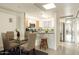 Bright dining area with a glass table next to the open kitchen showcasing stainless steel appliances at 6936 E 4Th St # 5, Scottsdale, AZ 85251