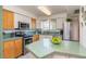 Bright kitchen featuring stainless steel appliances, two-tone cabinets, and a light green countertop at 6936 E 4Th St # 5, Scottsdale, AZ 85251