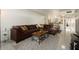 Relax in this open living space with views to the kitchen, featuring a large leather couch and a modern rug at 6936 E 4Th St # 5, Scottsdale, AZ 85251