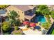 Aerial view of a private backyard with a sparkling pool, lush landscaping, covered patio, and outdoor kitchen at 7039 W Katharine Way, Peoria, AZ 85383