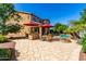 Beautiful backyard featuring a pool, outdoor kitchen, patio, and lush landscaping, perfect for outdoor living and entertaining at 7039 W Katharine Way, Peoria, AZ 85383