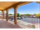 Outdoor balcony with a view of the neighborhood street and houses, secured by black metal railing at 7039 W Katharine Way, Peoria, AZ 85383