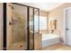 Well-appointed bathroom featuring tiled shower with a glass door and a separate soaking tub at 7039 W Katharine Way, Peoria, AZ 85383